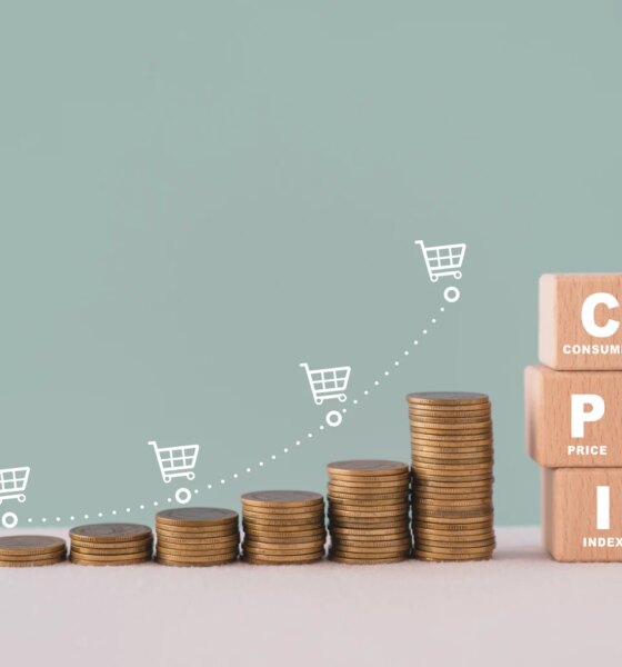 CPI, consumer price index concept. Wooden block with CPI word and stack of coins and increasing graph with shopping cart icon. Goods price inflation and inflation rising. Impact on economic growth