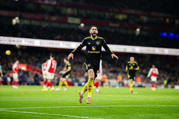 Matheus Cunha of Manchester United celebrates scoring a goal to make the score 2-3 during the Premier League match between Arsenal and Manchester...