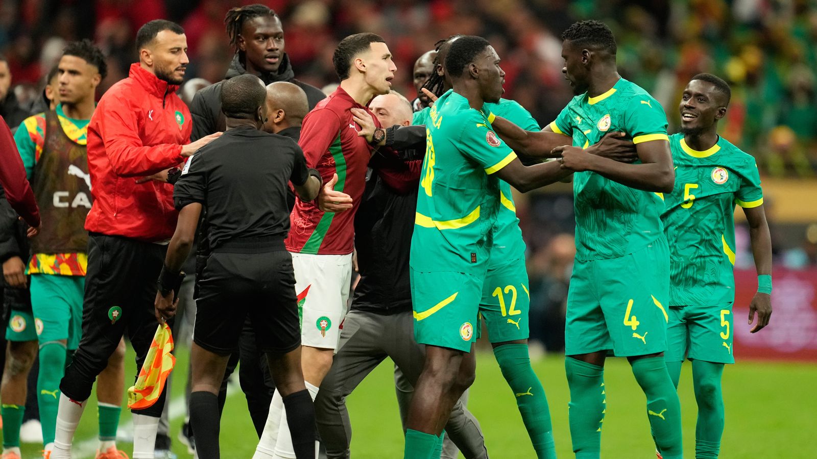 Senegal's and Morocco[s players scuffle after a penalty call during the Africa Cup of Nations final soccer match between Senegal and Morocco, in Rabat, Morocco, Sunday, Jan. 18, 2026. (AP Photo/Mosa'ab Elshamy)