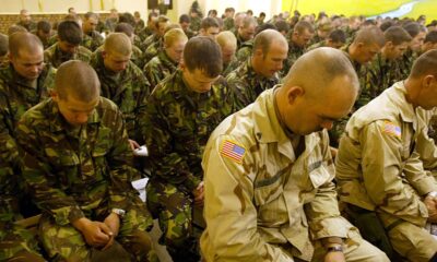 British and US soldiers hold a minute silence in Afghanistan in 2002. Pic: Reuters