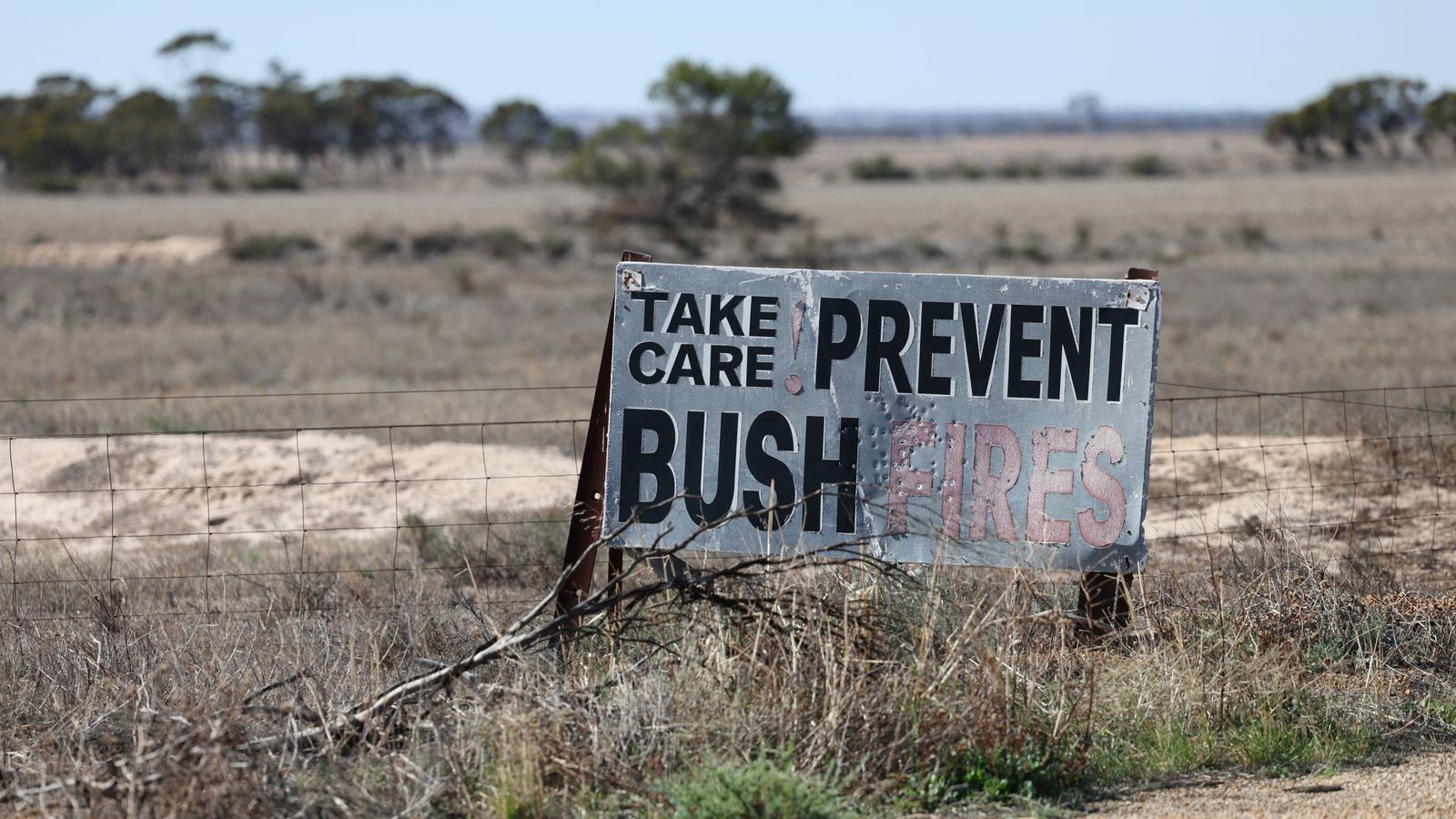 A sign promoting bushfire awareness lines the road near Wongan Hills, Australia. Pic: Reuters