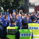 Workers at a consumer electronics factory in Shenzhen protest after a reduction in overtime availability