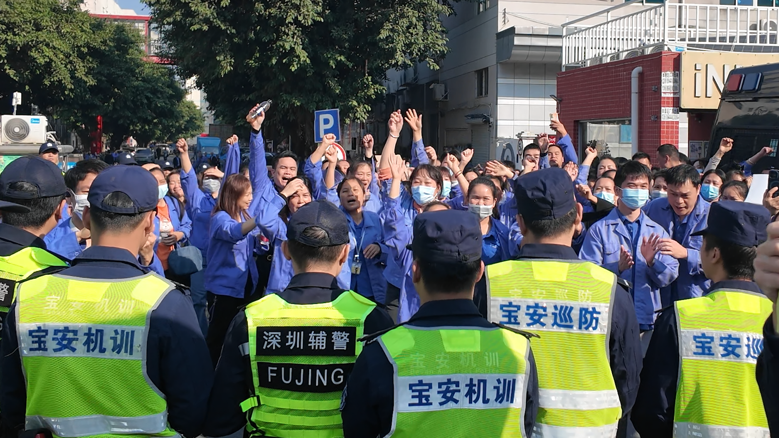 Workers at a consumer electronics factory in Shenzhen protest after a reduction in overtime availability