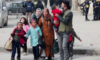 People have been evacuating with whatever they can carry. Pic: Reuters