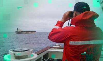 A US Coast Guard official looks through binoculars at the ship Marinera. Pic: US European Command