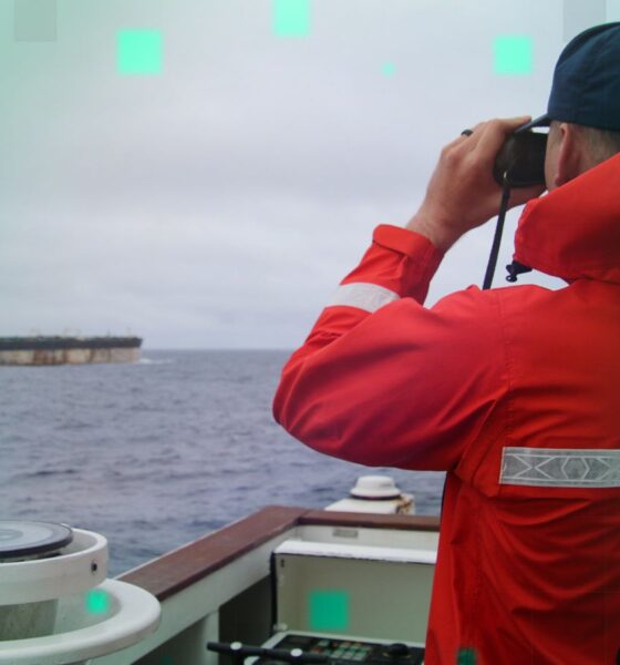 A US Coast Guard official looks through binoculars at the ship Marinera. Pic: US European Command