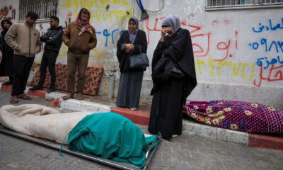 Mourners gather next to bodies at funeral of Palestinians who, according to medics, were killed after a wall collapsed. Pic: Reuters