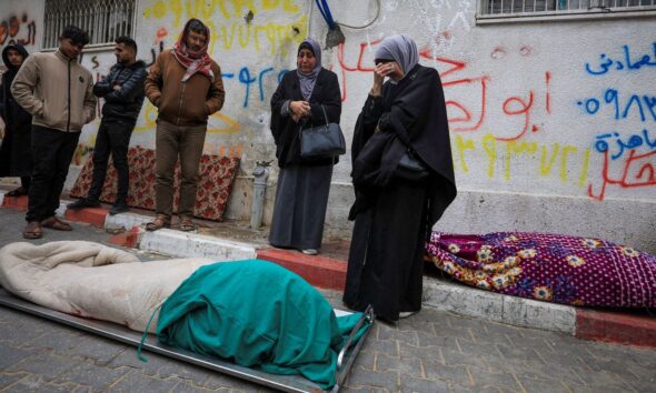 Mourners gather next to bodies at funeral of Palestinians who, according to medics, were killed after a wall collapsed. Pic: Reuters