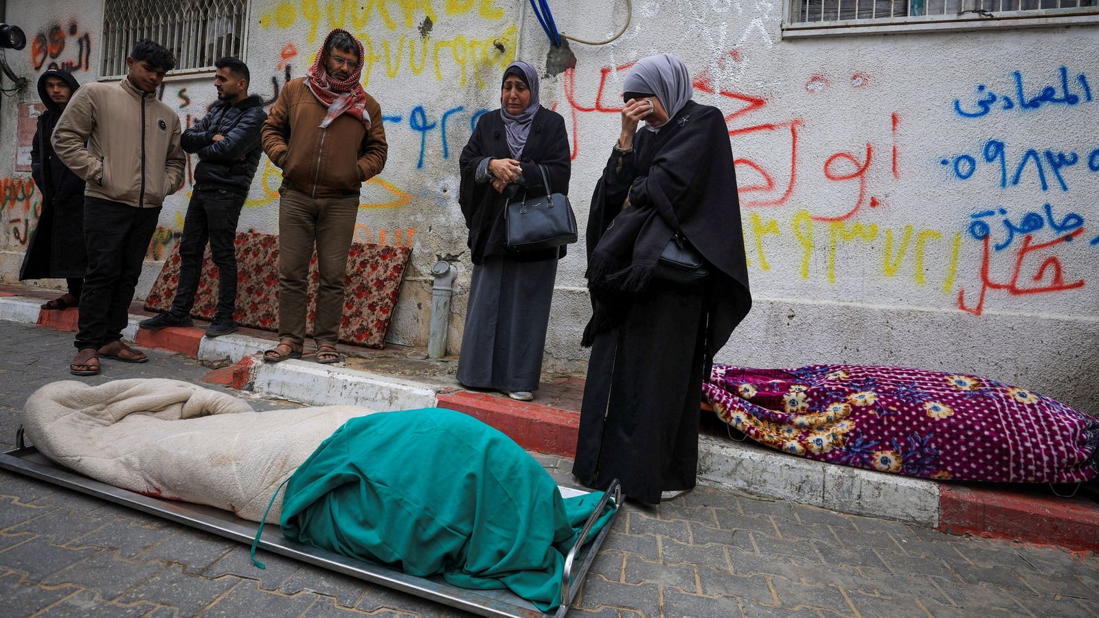 Mourners gather next to bodies at funeral of Palestinians who, according to medics, were killed after a wall collapsed. Pic: Reuters