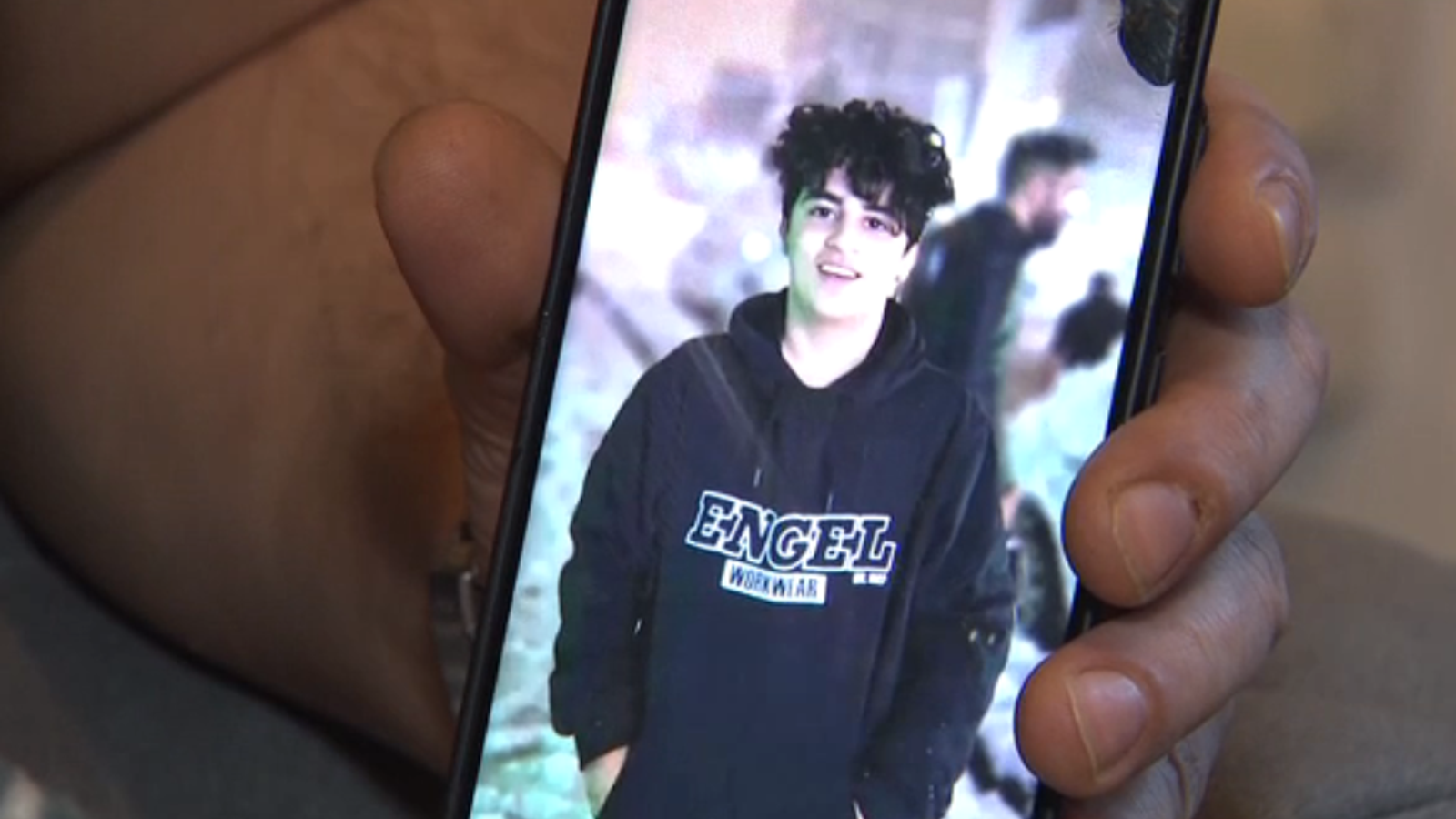 Amir Ali Haydari's cousin shows us a photo of his cousin.