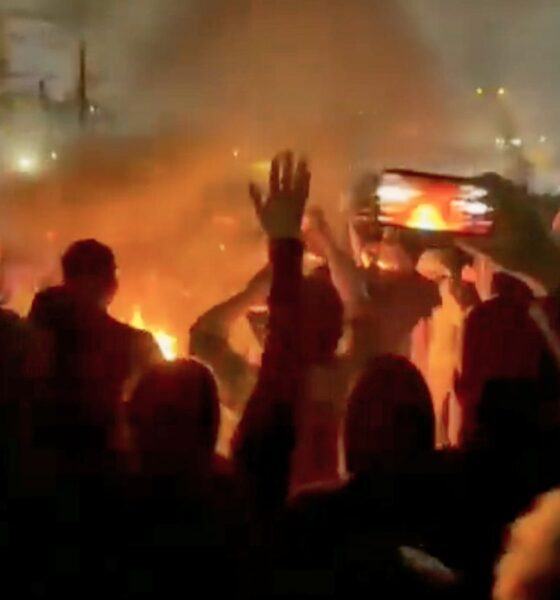 Protesters are seen in social media footage as they are dancing and cheering around a bonfire in Iran. Pic: AP