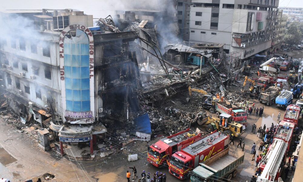 Rescue workers sift through the remains of the shopping centre. Pic: AP