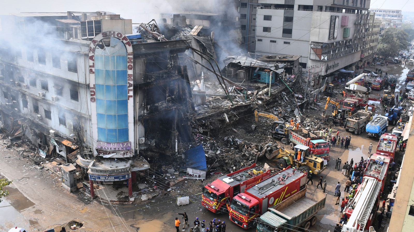 Rescue workers sift through the remains of the shopping centre. Pic: AP