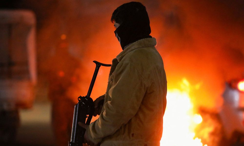 A Kurdish volunteer at a checkpoint in Qamishli, Syria. Pic: Reuters