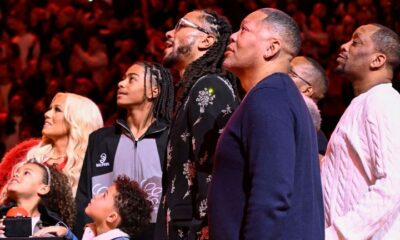 Former Chicago Bulls player Derrick Rose looks on with family members during a jersey retirement ceremony (Associated Press)