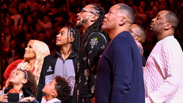 Former Chicago Bulls player Derrick Rose looks on with family members during a jersey retirement ceremony (Associated Press)