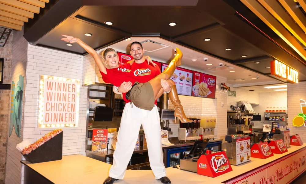 Alan Bersten holding Emma Slater on Raising Cane's counter