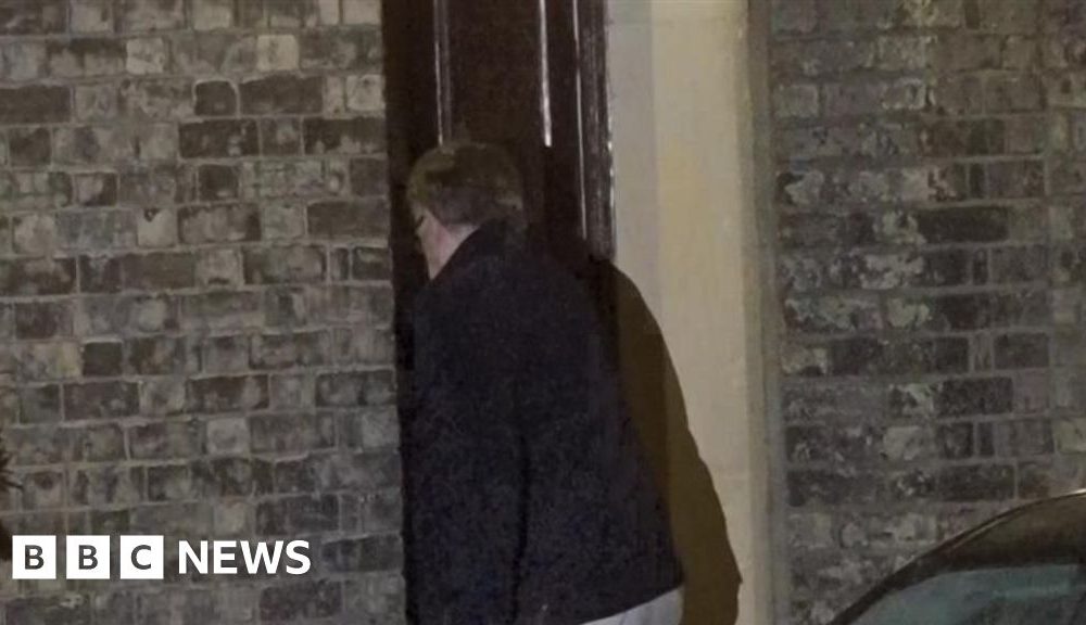 Lord Mandelson arrives at home after being released on bail