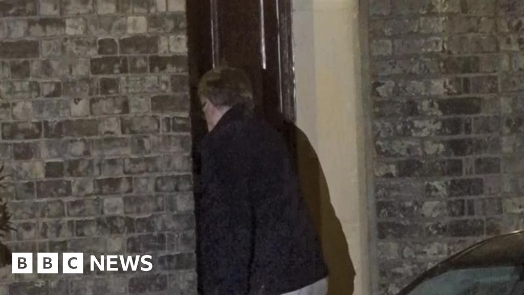 Lord Mandelson arrives at home after being released on bail