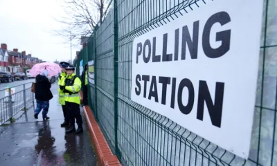 Voters in the Longsight area of Manchester, northwest England, enter a polling station, Thursday Feb. 26, 2026, as voters head to the polls in the Gorton and Denton constituency. (AP Photo/Jon Super)