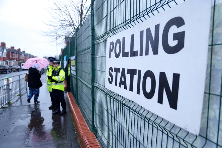 Voters in the Longsight area of Manchester, northwest England, enter a polling station, Thursday Feb. 26, 2026, as voters head to the polls in the Gorton and Denton constituency. (AP Photo/Jon Super)