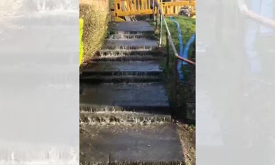 Oldhams Estate leak reported, water seen flowing down steps