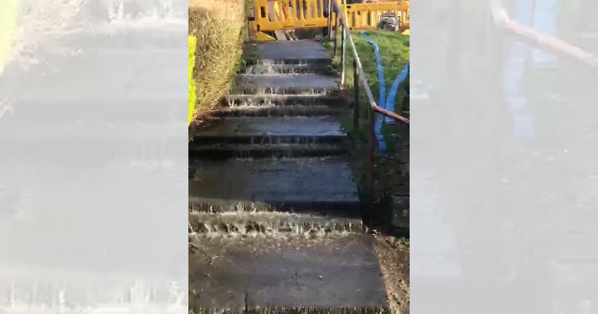 Oldhams Estate leak reported, water seen flowing down steps