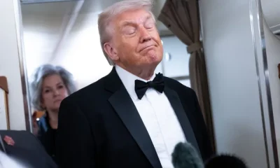 President Donald Trump speaks to members of the media aboard Air Force One on Saturday.