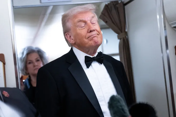 President Donald Trump speaks to members of the media aboard Air Force One on Saturday.