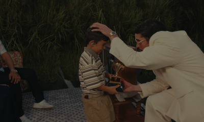 Bad Bunny presents a child performer with one of his Grammys during Sunday night's Super Bowl Halftime Show