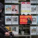 A man walks past a campaign poster for labour candidate Angeliki Stogia in an estate agents window in Longsight on February 11, 2026 in Manchester, United Kingdom.