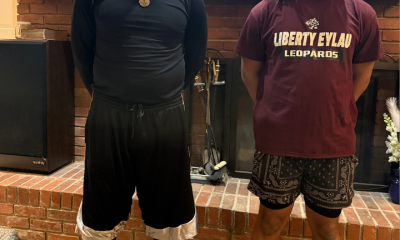 Scottie Smith (left) wears his signature long shorts next to his son.