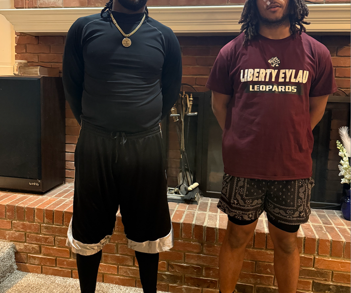 Scottie Smith (left) wears his signature long shorts next to his son.