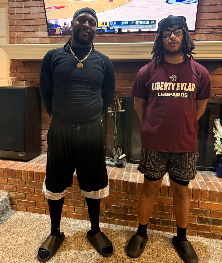 Scottie Smith (left) wears his signature long shorts next to his son.