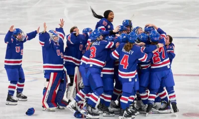 Members of Team USA women's ice hockey celebrate Megan Keller's game-winning overtime goal against Canada at Milano Santagiulia Ice Hockey Arena on Thursday.