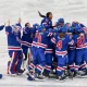 Members of Team USA women's ice hockey celebrate Megan Keller's game-winning overtime goal against Canada at Milano Santagiulia Ice Hockey Arena on Thursday.
