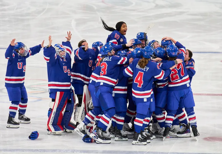Members of Team USA women's ice hockey celebrate Megan Keller's game-winning overtime goal against Canada at Milano Santagiulia Ice Hockey Arena on Thursday.
