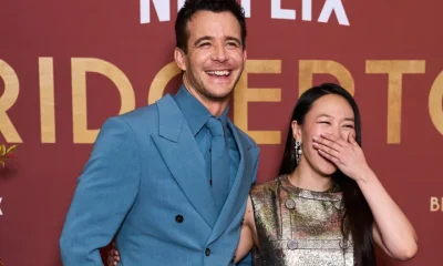 Luke Thompson and Yerin Ha having a laugh at a Bridgerton season four launch event