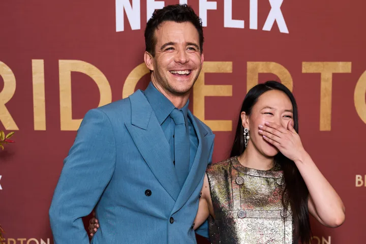 Luke Thompson and Yerin Ha having a laugh at a Bridgerton season four launch event