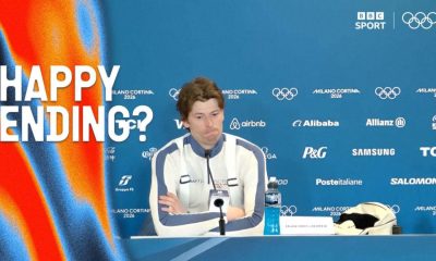 Sturla Holm Lægreid looks puzzled with his arms corssed in post biathlon presser