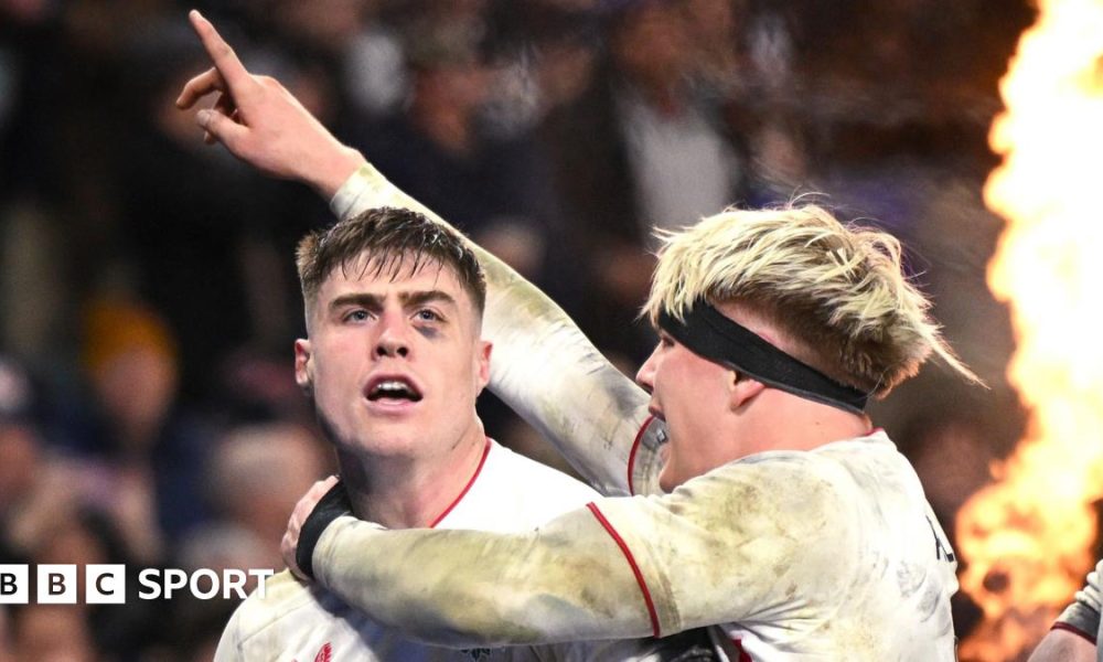 Dewi Lake with the English red rose flag behind him