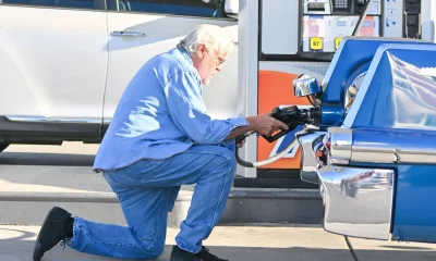 Jay Leno stops by a gas station in yet another cool car after getting out of the hospital yesterday