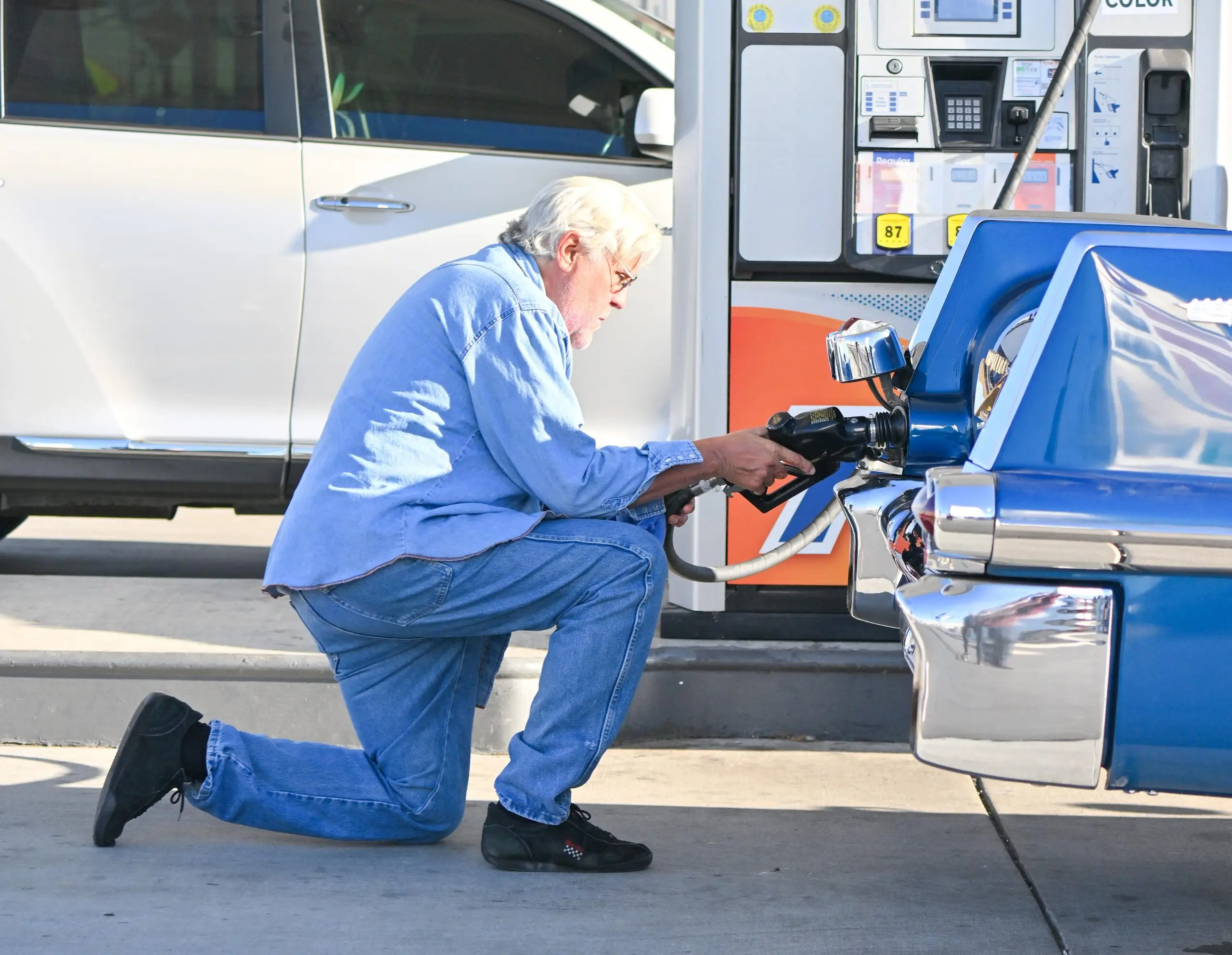 Jay Leno stops by a gas station in yet another cool car after getting out of the hospital yesterday