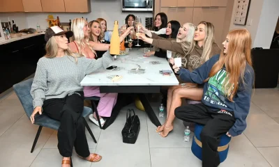 OF girls sitting at a table celebrating
