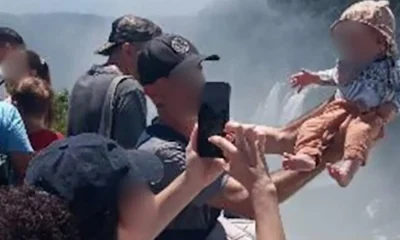 Tourist dangles baby over edge of 260ft waterfall for a holiday snap in Argentina | News World