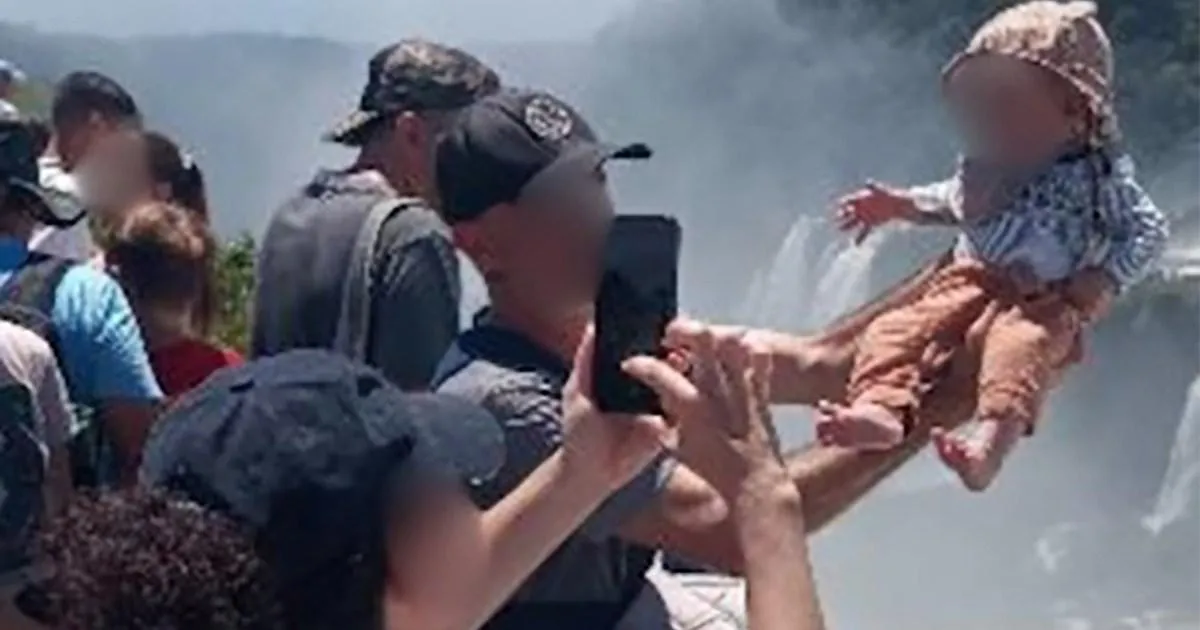 Tourist dangles baby over edge of 260ft waterfall for a holiday snap in Argentina | News World