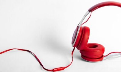 red headphones laid across white table