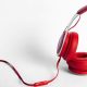 red headphones laid across white table