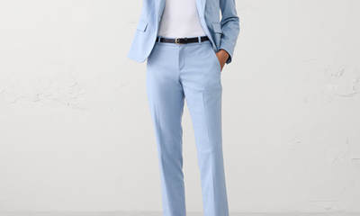 woman wears light blue suit with straight leg pants and shrunken jacket