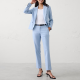 woman wears light blue suit with straight leg pants and shrunken jacket